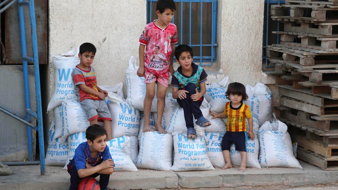 In this Friday, June 19, 2015 file photo, children sit on bags of rice from the World Food Programme at a school that serves as a shelter for internally displaced people in Baghdad's eastern district of Jamila, Iraq. The number of people displaced within Iraq due to violence and fighting by the Islamic State group has exceeded 3 million, the United Nations said Tuesday, June 23, a grim milestone for the war-battered country. (AP Photo/Karim Kadim, File)