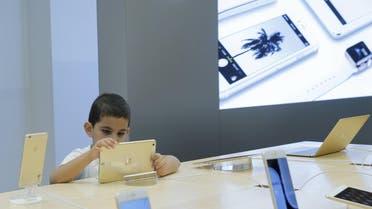 A boy views an iPad at an Apple shop in the Central Universal Department Store (TsUm) in Moscow