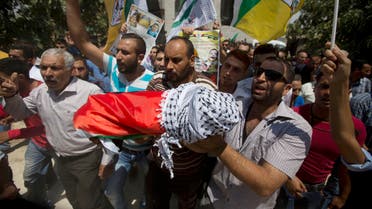 Palestinians carry the body of one-and-a-half year old boy, Ali Dawabsheh, during his funeral in Duma village near the West Bank city of Nablus, Friday, July 31, 2015. The sleeping toddler was burned to death when suspected Jewish assailants set fire to two Palestinian homes in a West Bank village early Friday, an attack that also critically wounded the child's 4-year-old brother and parents and outraged both Israelis and Palestinians. (AP Photo/Majdi Mohammed)