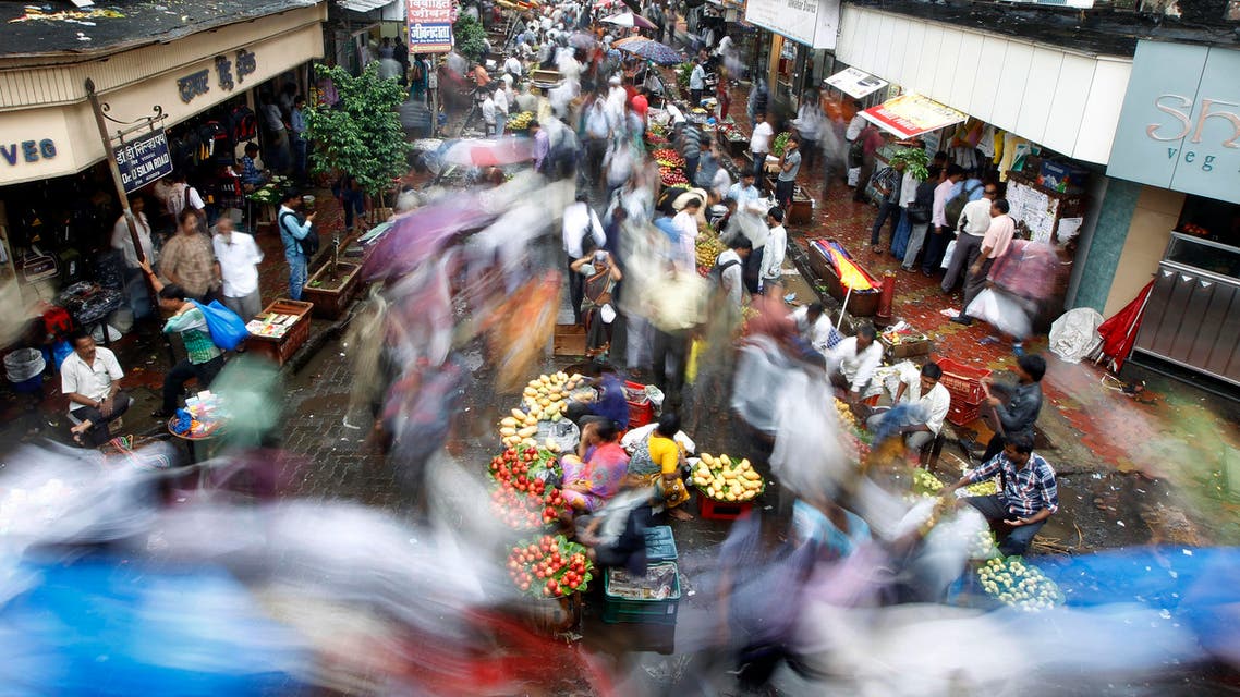 A crowd swarms a market area near a train station on World Population Day in Mumbai, India, Thursday, July 11, 2013.(AP Photo/Rajanish Kakade)