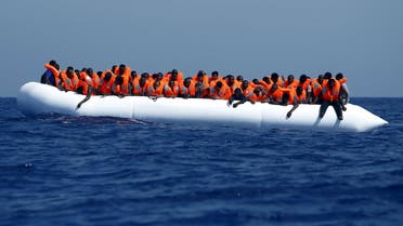 Migrants on a rubber dinghy wait to be rescued by the Migrant Offshore Aid Station (MOAS) ship MV Phoenix, some 20 miles (32 kilometres) off the coast of Libya, August 3, 2015.  (Reuters)