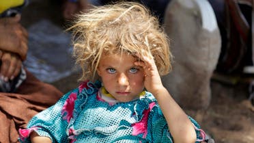  A girl from the minority Yazidi sect, fleeing the violence in the Iraqi town of Sinjar, rests at the Iraqi-Syrian border crossing in Fishkhabour, Dohuk province August 13, 2014. (Reuters)