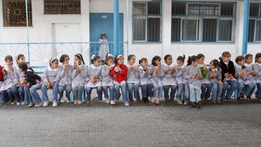  Palestinian school girls eat sandwiches provided by the United Nations, at a UN elementary school at Shati refugee camp in Gaza City, Thursday, Nov. 20, 2008. Israel's tightening Gaza blockade, a response to Palestinian militant rocket fire, has led to frequent blackouts throughout Gaza and resulted in shortages of food, supplies and even cash.(AP Photo/Adel Hana)