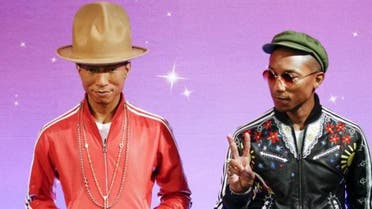 Musician Pharrell Williams makes peace symbol as he meets his wax double at Madame Tussauds in New York April 1, 2015. Reuters 