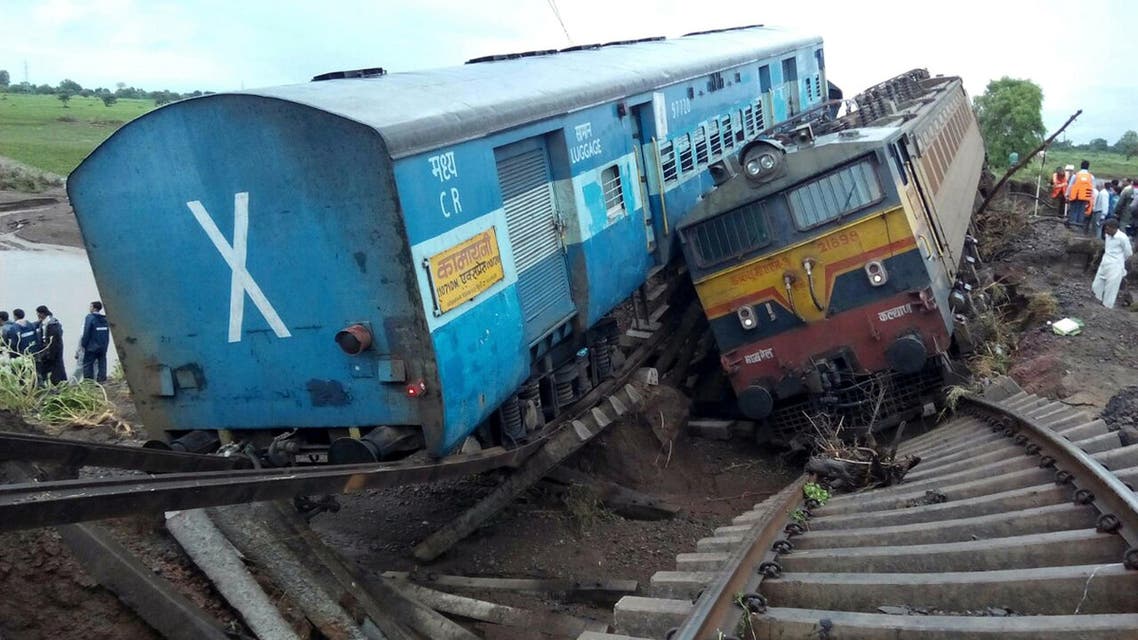TRA001 - Harda, MADHYA PRADESH, INDIA : Two Indian passenger trains lay next to each other following a derailment after they were hit by flash floods on a bridge outside the town of Harda in Madhya Pradesh state on August 5, 2015. Two passenger trains derailed after being hit by flash floods on a bridge in central India, killing at least 27 people in the latest deadly accident on the nation's crumbling rail network. AFP PHOTO