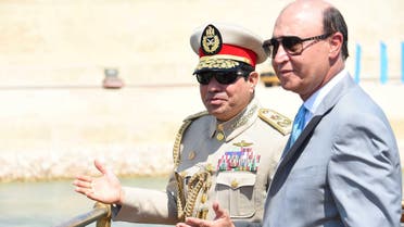 Egyptian President Abdel Fattah al-Sisi (L) talks to Mohab Mameesh, chairman of the Suez Canal Authority, as they attend the celebration of an extension of the Suez Canal in Ismailia, Egypt, August 6, 2015. Egypt will open an expansion to the Suez Canal to great fanfare on Thursday, the centrepiece of al-Sisi's plans to revitalise the country's economy after years of damaging political turmoil. In this handout courtesy of the Egyptian Presidency. REUTERS/The Egyptian Presidency/Handout