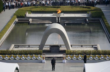 Japan's Prime Minister Shinzo Abe (C bottom) bows as he attends a ceremony at the Peace Memorial Park in Hiroshima, western Japan, August 6, 2015, on the 70th anniversary of the world's first atomic bombing. Bells tolled and thousands bowed their heads in prayer in Hiroshima on Thursday at ceremonies that marked the 70th anniversary of the world's first atomic bombing and highlighted rising tensions over Japan's moves away from its pacifist constitution. REUTERS/Toru Hanai