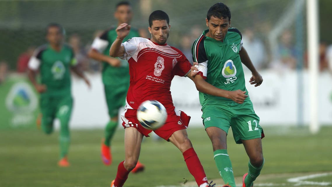Palestinian Hebron's Al-Ahly Osama Shaban (L) fights for the ball with Gaza Strip's Shejaia Salem Wadi during their first leg of the Palestine Cup final soccer match at al-Yarmouk stadium in Gaza City August 6, 2015. A Palestinian team from the Gaza Strip hosted West Bank opposition for the first time in 15 years on Thursday after Israel gave the visitors permission to cross its territory for the clash between the two lands' respective cup holders. The Gaza Strip's Shejaia and Al-Ahly from Hebron in the Israeli-occupied West Bank played in a fixture that appeared in doubt before the permit granted by Israel, whose territory separates Gaza and the West Bank. REUTERS/Mohammed Salem