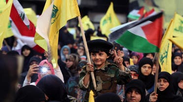 A Lebanese boy holds a Hezbollah flag during a rally to mark Al-Quds (Jerusalem) day, in the southern suburb of Beirut, Lebanon, Friday, July 10, 2015. (AP)
