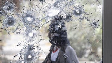 Southern Resistance fighter is pictured through a damaged door glass as he stands guard at the international airport of Yemen's southern port city of Aden. (File: Reuters)