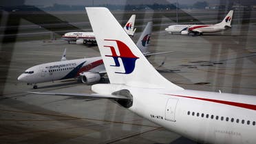 A fleet of Malaysia Airlines planes are seen against the reflection facade of Kuala Lumpur International Airport in Sepang, Malaysia on Saturday, July 11, 2015. Malaysia hosted the first memorial ceremony for the ill fated flight MH17 Saturday. Controversy continues over who downed the plane, bound from Amsterdam to Kuala Lumpur, killing all 298 people on board on July 17, 2014. (AP Photo/Joshua Paul)