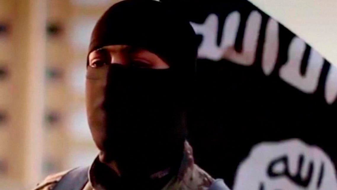 A masked man speaking in what is believed to be a North American accent in a video that Islamic State militants released in September 2014 is pictured in this still frame from video obtained by Reuters October 7, 2014