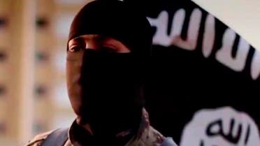 A masked man speaking in what is believed to be a North American accent in a video that Islamic State militants released in September 2014 is pictured in this still frame from video obtained by Reuters October 7, 2014