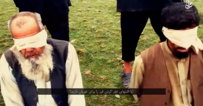 Seen here just moment before death, the blindfolded prisoners are forced to kneel (Video grab)