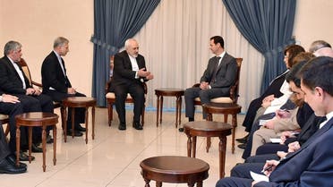 A handout picture released by the official Syrian Arab News Agency (SANA) shows Iranian Foreign Minister Mohammad Javad Zarif (C-L) meeting with Syrian President Bashar al-Assad (C-R) and other officials in Damascus on August 12, 2015. AFP 