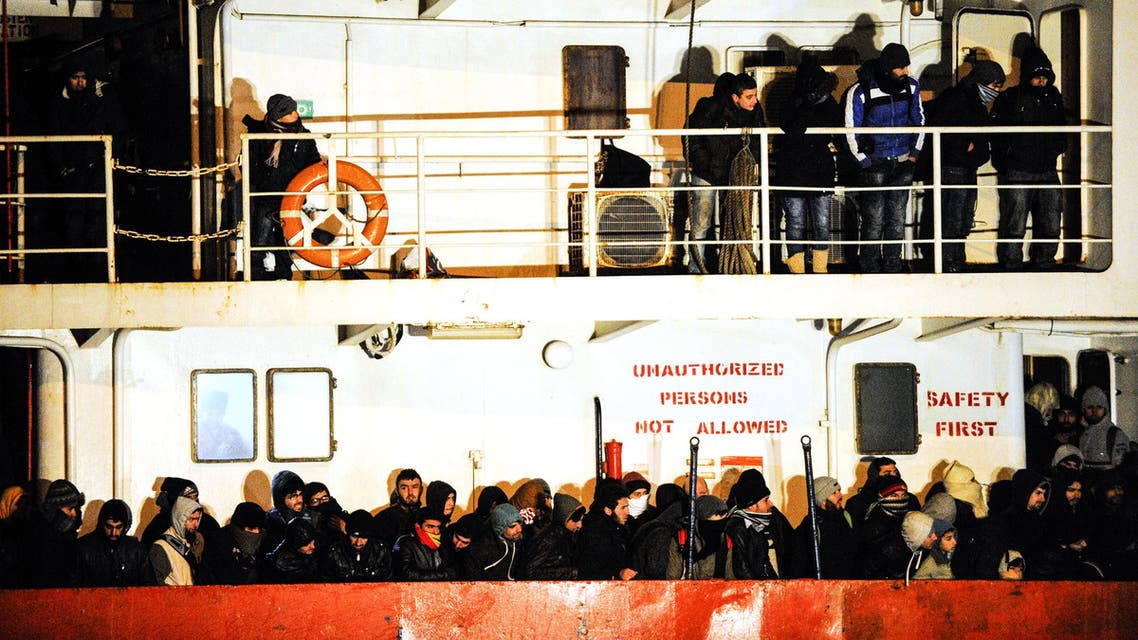 CTL4785 - Gallipoli, -, ITALY : (FILES) A file picture taken on December 31, 2014 shows immigrants waiting early aboard the Moldovan-flagged ship Blue SKy M. in the port of Gallipoli, in southeastern of Italy. A Syrian man, suspected of being part of the crew of the "Blue Sky M", an old ship which smuggled migrants in Italy in late December, was arrested in Germany on August 12, 2015, Italian investigators announced. Some 800 illegal migrants arrived in Italy on December 31 after their boat was intercepted while drifting towards the coast of Corfu. AFP PHOTO / NUNZIO GIOVE
