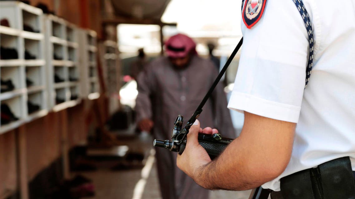 A Bahraini police officers stands guard outside of Shiite Muslim mosque ahead of mid-day prayers during the holy month of Ramadan in the western village of Karzakan, Bahrain, Friday, July 3, 2015. AP