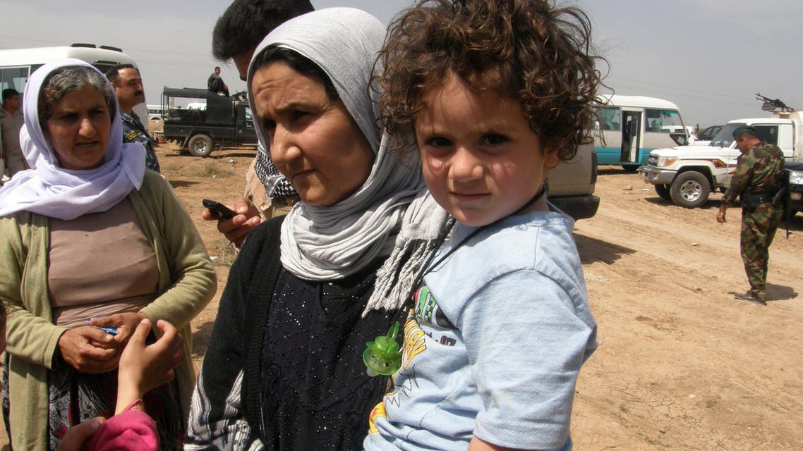 Yazidi women and children, released by Islamic State group militants, arrive in Kirkuk, 180 miles (290 kilometers) north of Baghdad, Iraq, Wednesday, April 8, 2015. AP