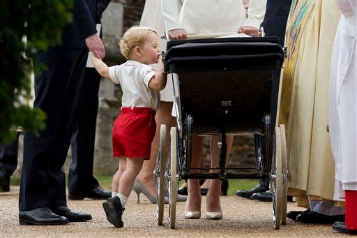In this Sunday, July 5, 2015 file photo, Britain's Prince George gets up on tiptoes to peek into the pram of Princess Charlotte flanked by his parents Prince William and Kate the Duchess of Cambridge as they leave after Charlotte's Christening at St. Mary Magdalene Church in Sandringham, England. Britain’s royals on Wednesday July 22 ,2015 celebrate the second birthday of George, the first child of Prince William and his wife, Kate. (AP Photo/Matt Dunham, file)