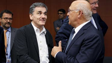 Greek Finance Minister Euclid Tsakalotos listens his French counterpart Michel Sapin (R) during a euro zone finance ministers meeting in Brussels, Belgium, August 14, 2015. (Reuters)