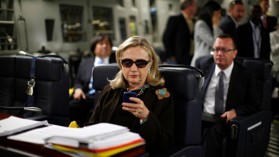 In this Oct. 18, 2011, file photo, then-Secretary of State Hillary Rodham Clinton checks her Blackberry from a desk inside a C-17 military plane upon her departure from Malta, in the Mediterranean Sea, bound for Tripoli, Libya. (AP)
