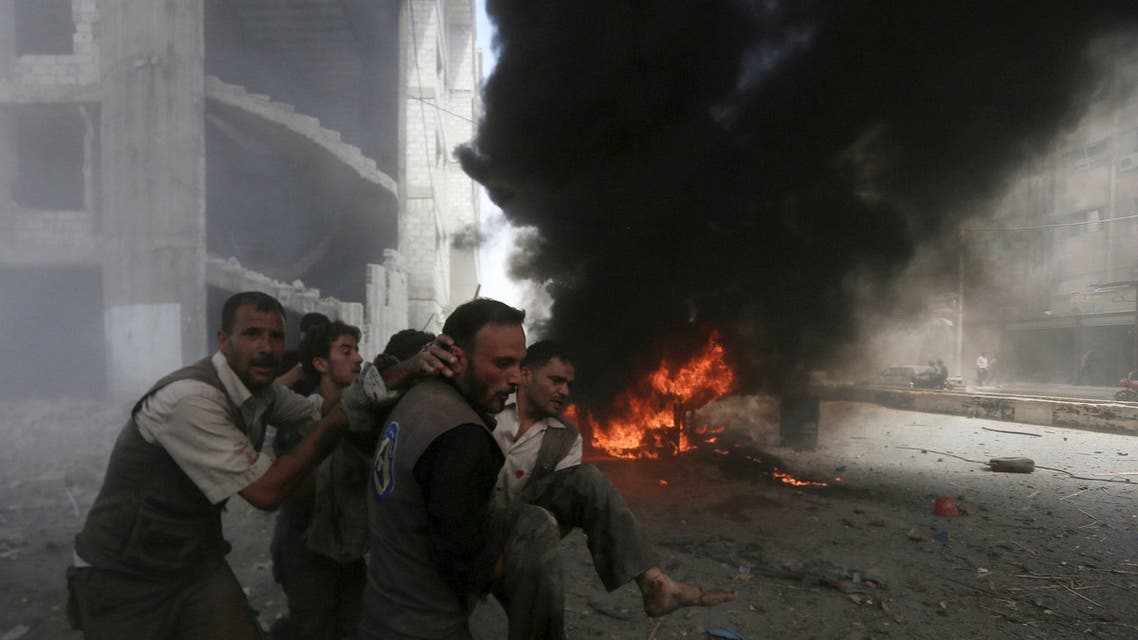 Men transport a casualty after what activists said were air strikes by forces loyal to Syria's President Bashar al-Assad on a market place in the Douma neighborhood of Damascus, Syria. (Reuters)