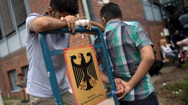 Asylum seekers wait in front of the Federal Office for Migration and Refugees (BAMF) at Berlin's Spandau district, Germany August 17, 2015. (Reuters)