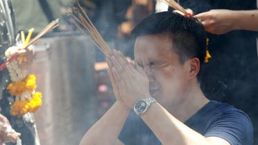 A man prays at the Erawan shrine, the site of Monday's deadly blast, in central Bangkok, Thailand, August 20, 2015. International terrorists were not suspected of the bomb attack in Bangkok this week that killed 20 people and China was not the target, Thai authorities said on Thursday, as police said they believed at least 10 plotters were involved. REUTERS/Kerek Wongsa