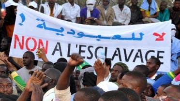 People hold a banner reading "No to slavery" during a demonstration in Nouakchott on April 29, 2015 (AFP)