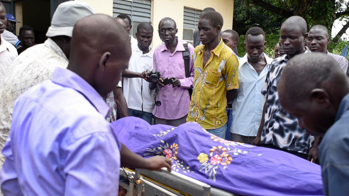 Relatives and other mourners watch as the body of South Sudanese journalist Peter Julius Moi is taken into the mortuary in Juba, South Sudan Thursday, Aug. 20, 2015. (AP)