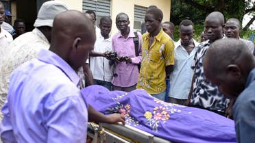 Relatives and other mourners watch as the body of South Sudanese journalist Peter Julius Moi is taken into the mortuary in Juba, South Sudan Thursday, Aug. 20, 2015.  (AP)