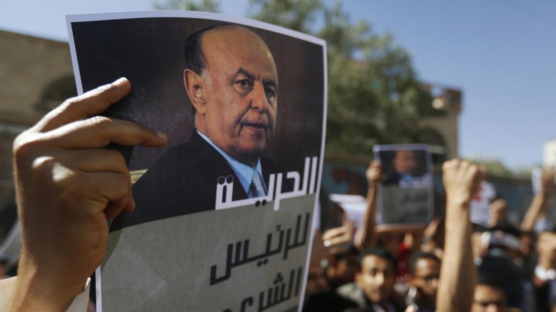 A protester holds up a poster of Yemen's President Hadi during an anti-Houthi demonstration in Sana'a. (File photo: Reuters)
