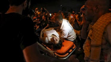 A wounded woman is moved on a stretcher by medics during a protest against corruption and rubbish collection problems near the government palace in Beirut, August 22, 2015. (Reuters)