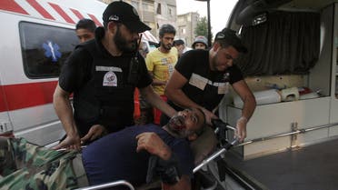 Members of the emergency services carry a wounded man on a stretcher following clashes in Ain El-Helweh Palestinian refugee camp near Lebanon's southern port city of Sidon on August 22. (AFP)