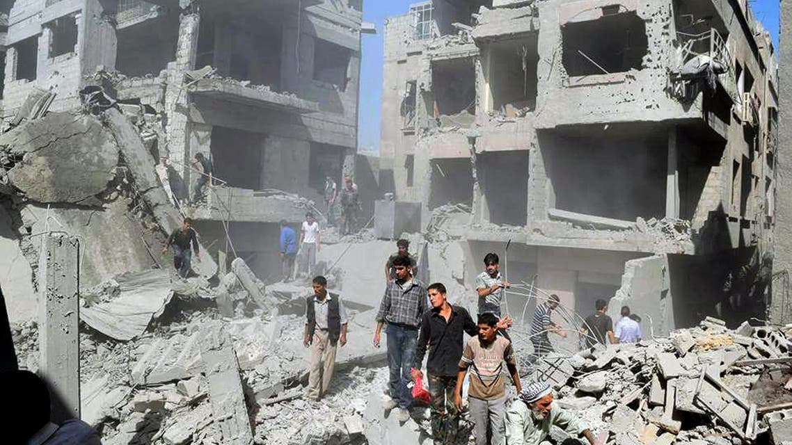 This picture released by the Douma Revolution News Network on their Facebook page, shows Syrians inspecting damage following a Syrian government airstrike on the Damascus suburb of Douma, Syria, Saturday, Aug. 22, 2015. Syrian activists said that at least 20 people have been killed and dozens wounded in government airstrikes on Douma. (Firas Abdullah/Douma Revolution News Network Facebook page via AP)