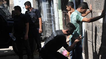 Turkish police officers search youths as they conduct a security operation in Diyarbakir, southeastern Turkey, Saturday, Aug. 15, 2015. (AP)