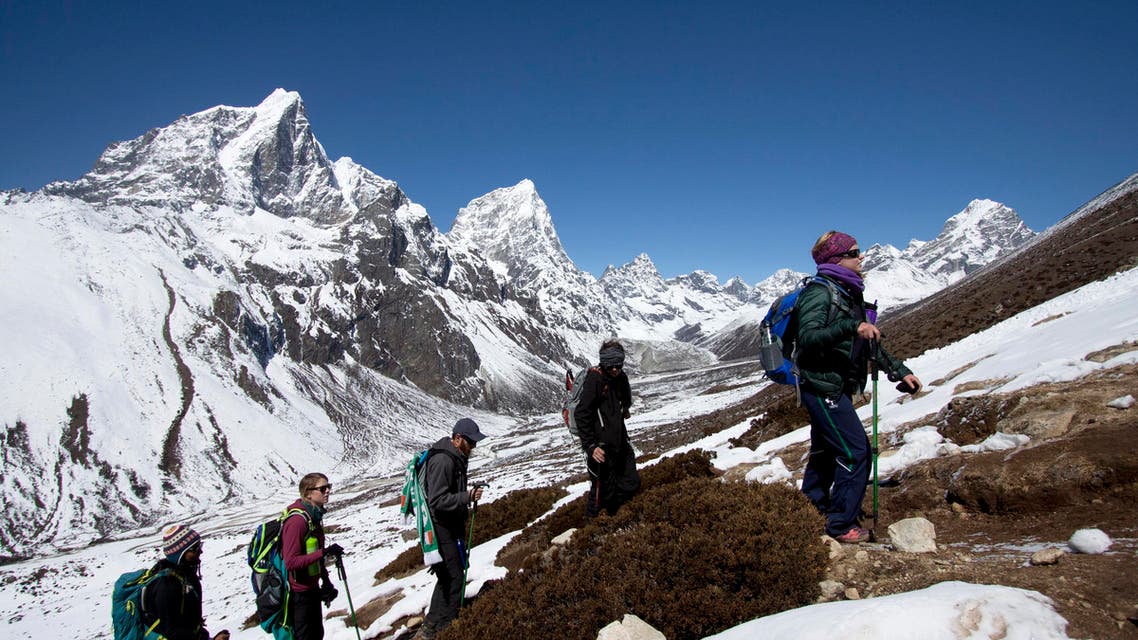 FILE - In this May 16, 2013 file photo, Nepalese Sherpas rest as they climb Mount Everest. Everest Day, marking the conquest of the world's tallest peak 62 years ago, was marked quietly by officials, people in the mountaineering business and a few climbers Friday, May 29, 2015 little more than a month after an earthquake-triggered avalanche swept the base camp and killed 19 people. (AP Photo/Pasang Geljen Sherpa, File)