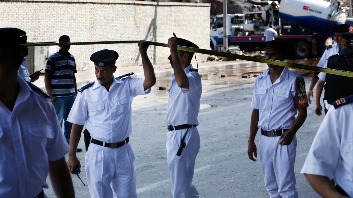 Egyptian policemen gather outside of the Italian consulate following a blast that killed at least one person in Cairo, Egypt, Saturday, July 11, 2015. AP