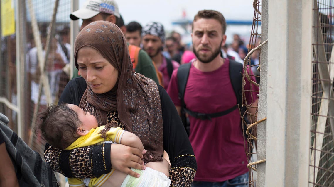 Migrants and refugees walk to board an Athens-bound ferry, on the southeastern island of Kos, Greece. (File: AP)