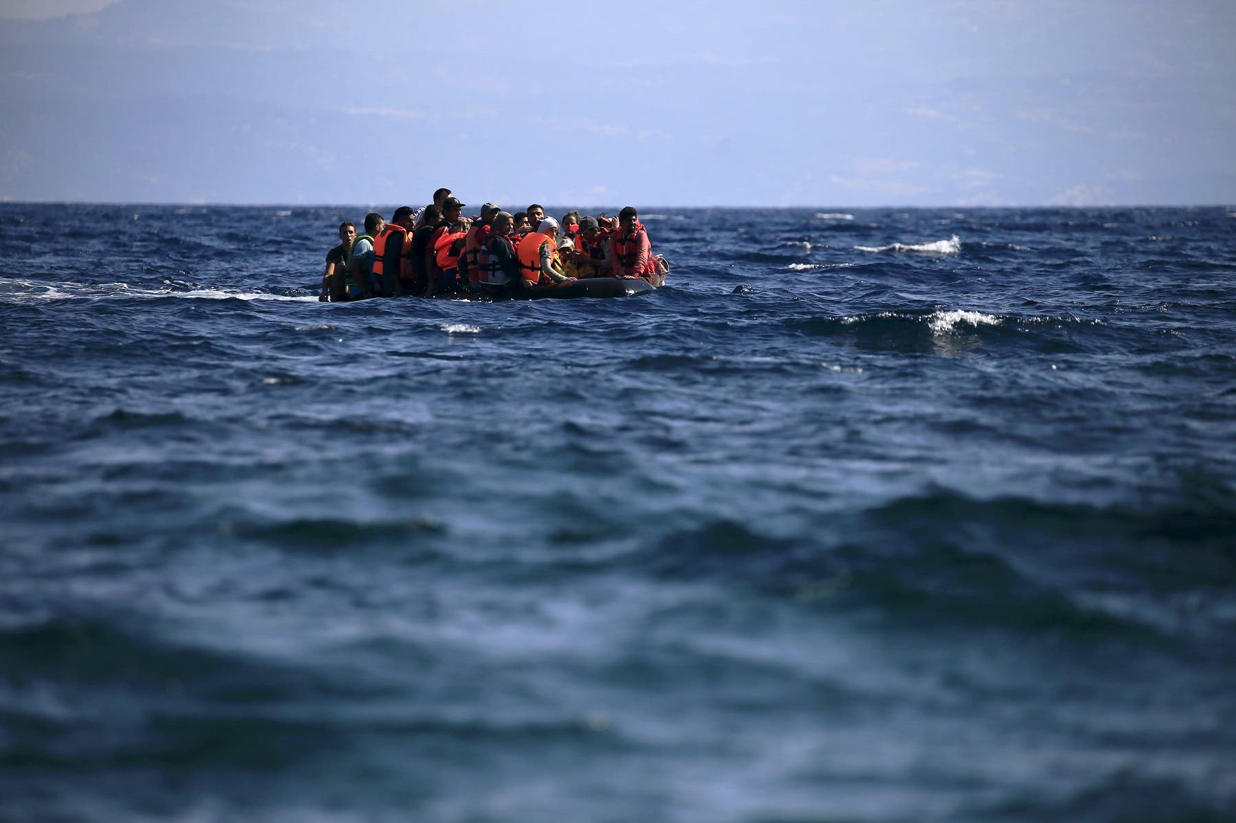 Syrian refugees on a dinghy approach, in rough seas, a beach on the island of Lesbos, Greece August 23, 2015. (Reuters)