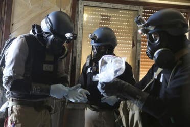 UN chemical weapons expert holds a plastic bag containing samples from one of the sites of an alleged chemical weapons attack in Ain Tarma, Syria. (File photo: Reuters)