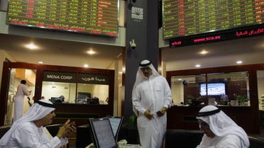 Emirati traders check stocks at the Dubai Financial Market in United Arab Emirates (Reuters)