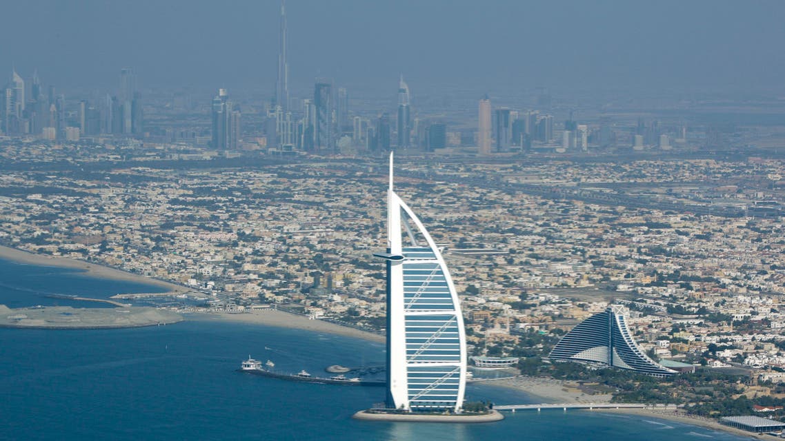 Burj Al Arab, the luxury hotel foreground, and Burj Dubai, the world's tallest building, in background centre are seen from the plane in Dubai, United Arab Emirates, Sunday, Jan. 3, 2010. (AP)