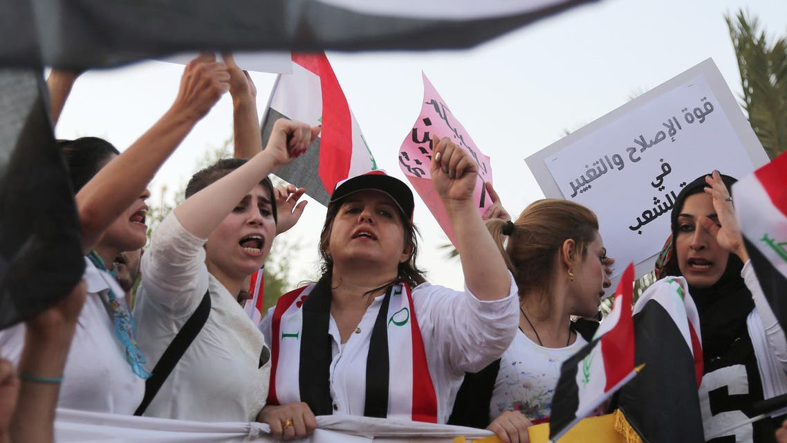 Protesters chant in support of Iraqi Prime Minister Haider al-Abadi as they carry national flags during a demonstration in Tahrir Square in Baghdad, Iraq, Friday, Aug. 21, 2015. AP
