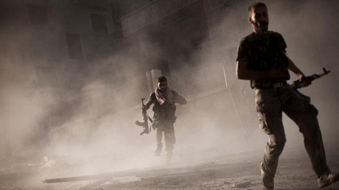 free Syrian Army fighters run after attacking a Syrian Army tank during fighting in the Izaa district in Aleppo, Syria, September 7, 2012. (AP)