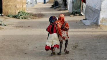 mi and Ashbu, both three-years-old, walk arm in arm in the Zafaye refugee camp, some 15 kms (10 miles) from downtown N'djamena, Chad. (File photo: AP)