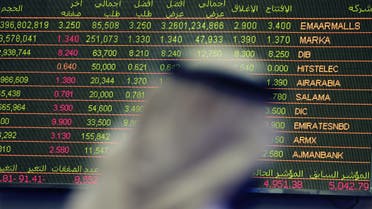  An Emirati trader checks the stocks of Emaar Malls on the screen at the Dubai Financial Market in United Arab Emirates, Thursday, Oct. 2, 2014. Shares in the owner of the Middle East's largest mall jumped over 12 percent in the first day of trading on the Dubai stock exchange after its initial public offering. (AP Photo/Kamran Jebreili)