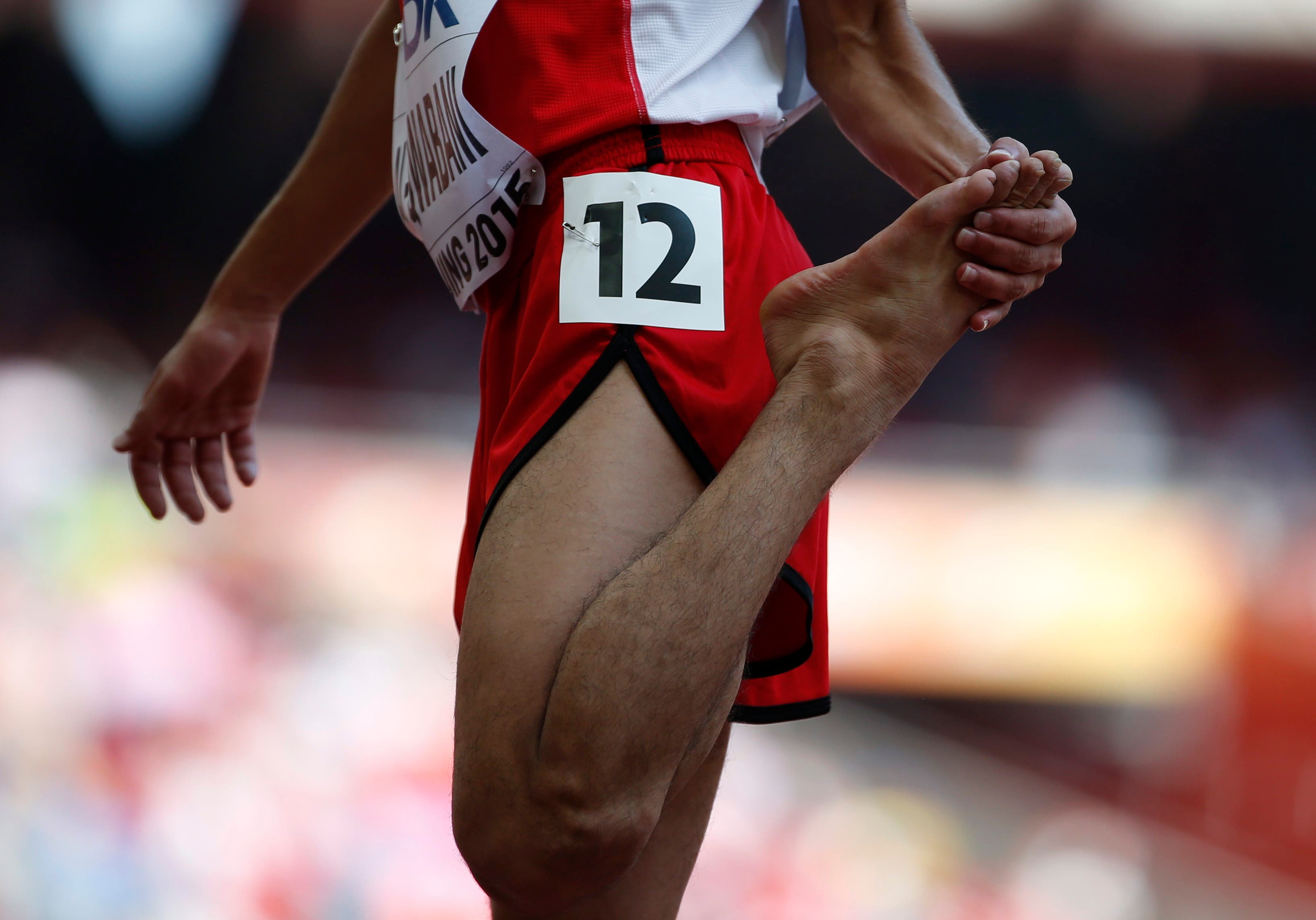 Abdullah Al-Qwabani of Yemen, who competed barefoot, looks at his foot after his men's 5000 metres heat at the IAAF World Championships at the National Stadium in Beijing, China August 26, 2015.  (Reuters)