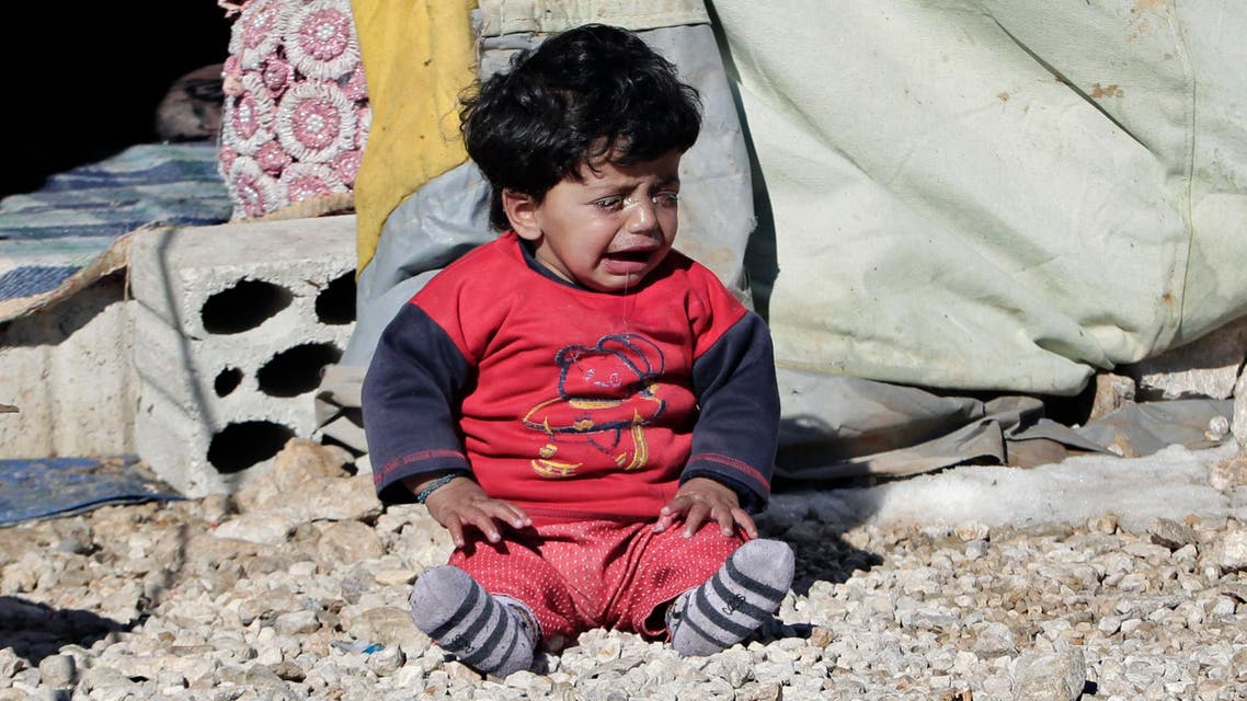 A Syrian refugee child cries outside his family tent at a refugee camp in the eastern Lebanese border town of Arsal, Lebanon, Sunday, Dec. 15, 2013. (AP)