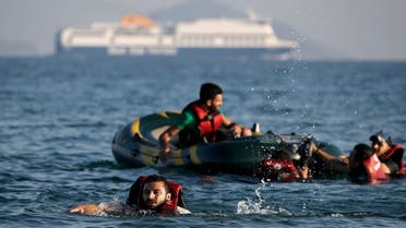 Syrian refugee swims towards a beach as others are seen on a dinghy whose engine broke down a few hundred metres from the shore of the Greek island of Kos after crossing over from Turkey. Reuters 